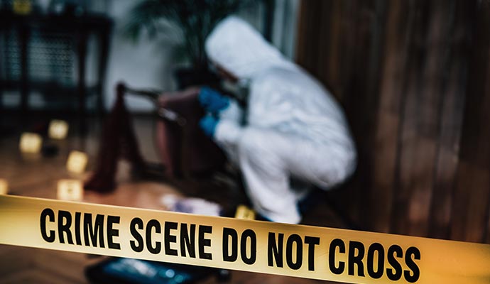 An expert performing biohazard cleanup in a restricted area