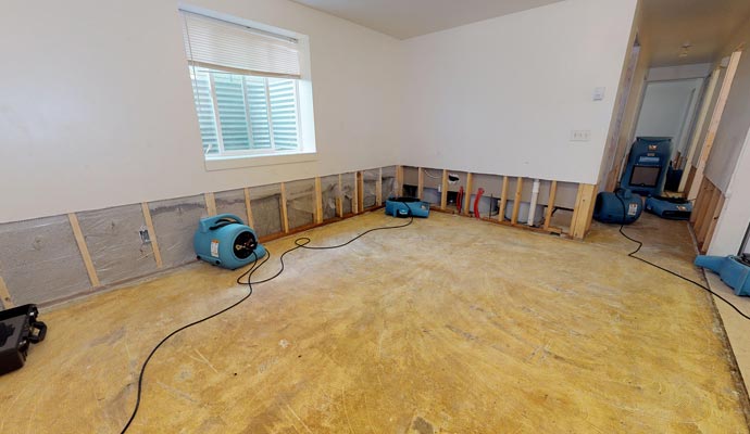 Water damage restoration process with industrial drying machines