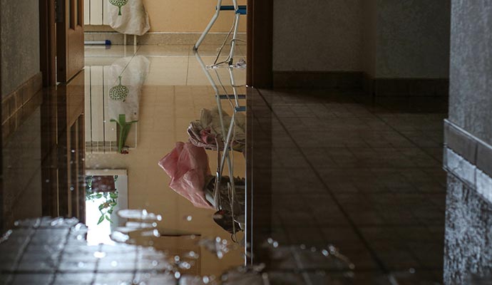 Water pooling on the floor due to plumbing leakage